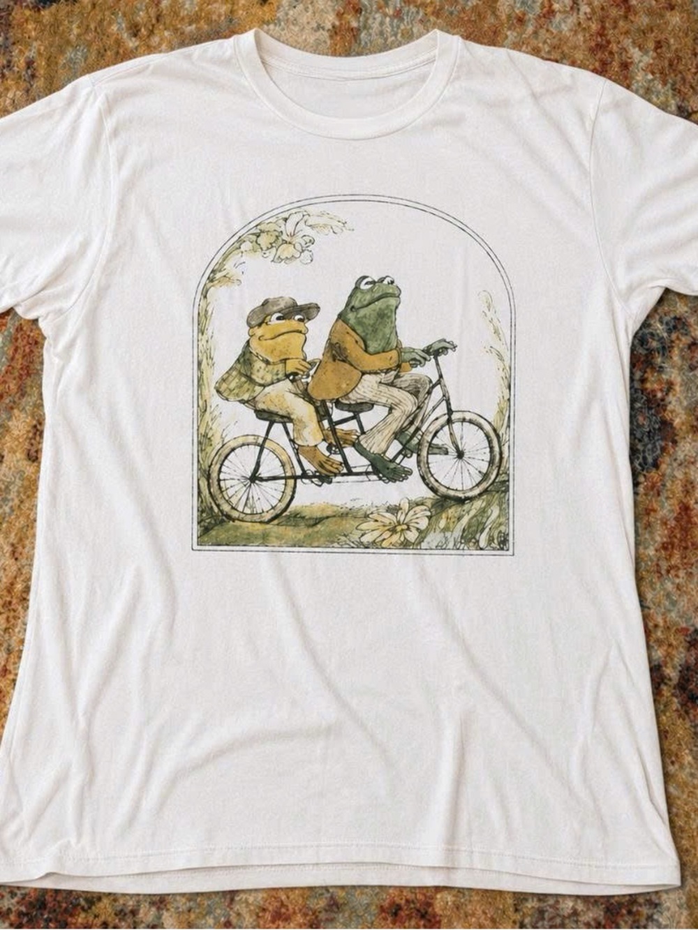 White Graphic T-Shirt with Frog Riding Bicycle Illustration